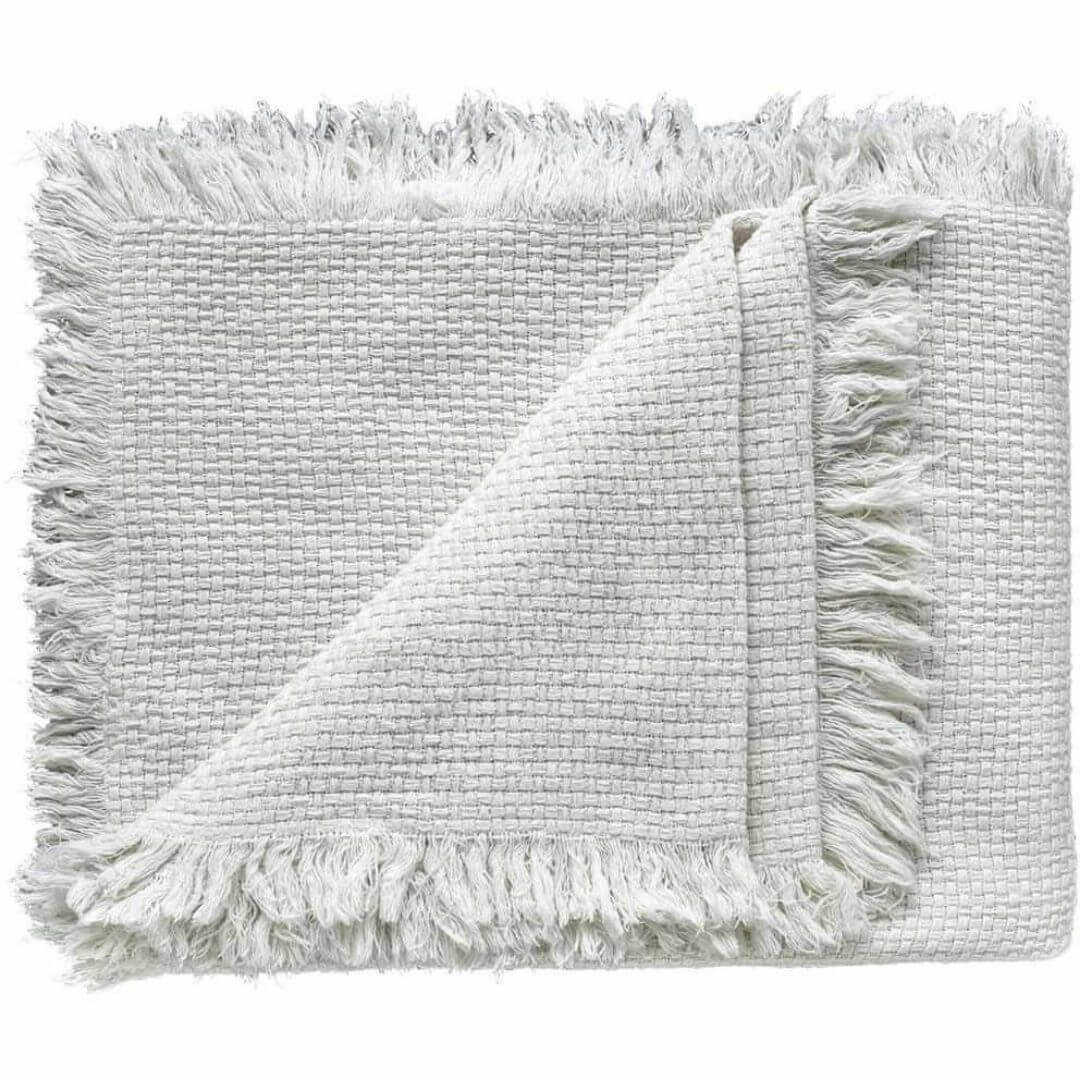 The Chelsea Cotton Throw with fringe measuring 150cm x 180cm in a stylish off white colour.