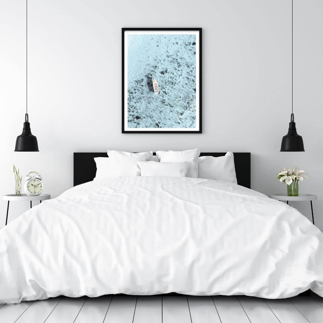 A wall art photo print of a white boat on a clear blue ocean off the Amalfi Coast Italy with a black frame for the wall in your bedroom