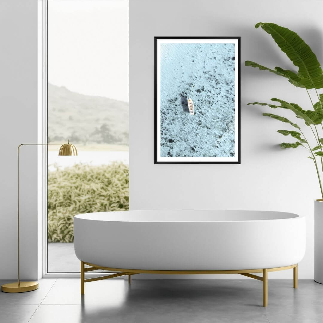 A wall art photo print of a white boat on a clear blue ocean off the Amalfi Coast Italy with a black frame or unframed for your bathroom walls