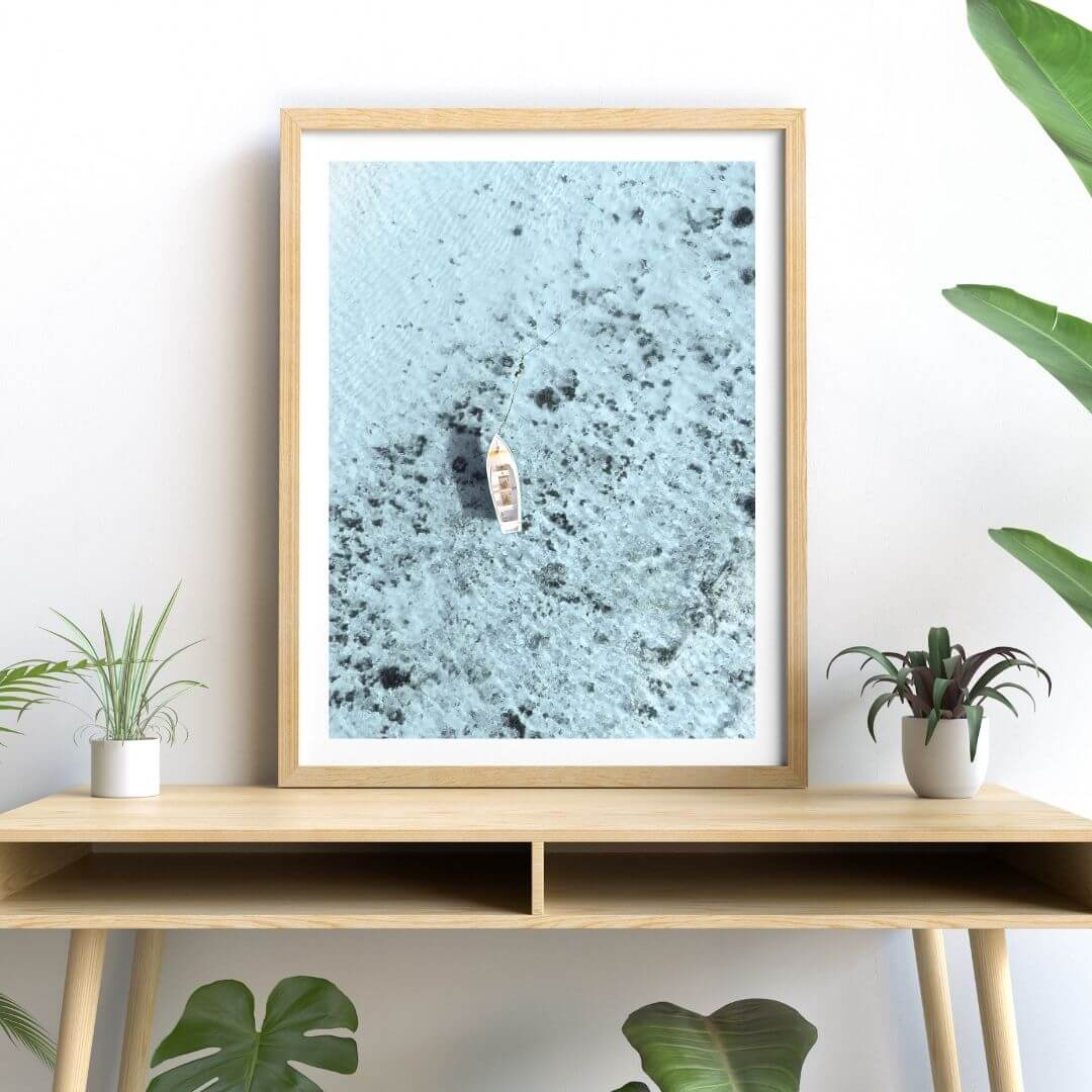 A wall art photo print of a white boat on a clear blue ocean off the Amalfi Coast Italy with a white frame or unframed to style shelves and empty walls