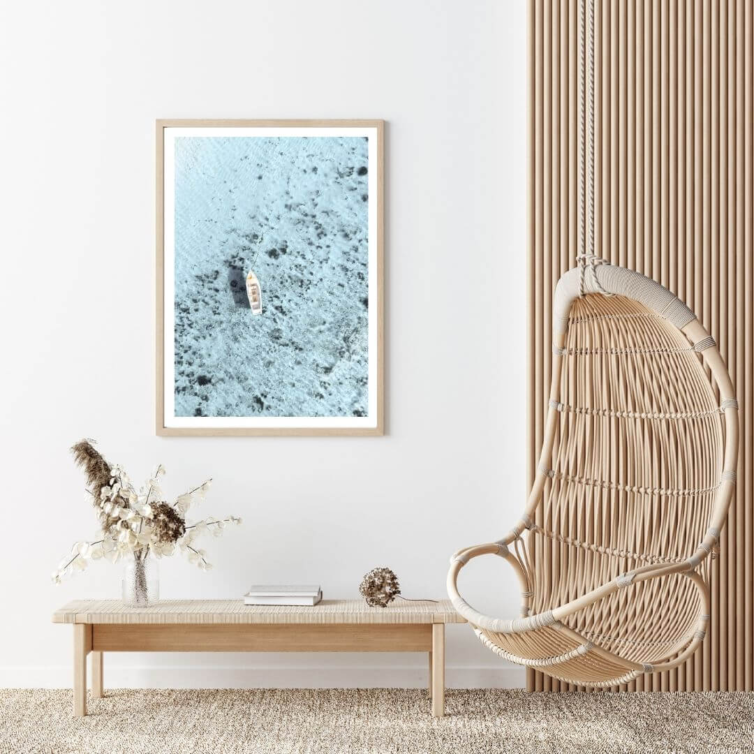 A wall art photo print of a white boat on a clear blue ocean off the Amalfi Coast Italy with a timber frame to decorate your hallway living room empty walls
