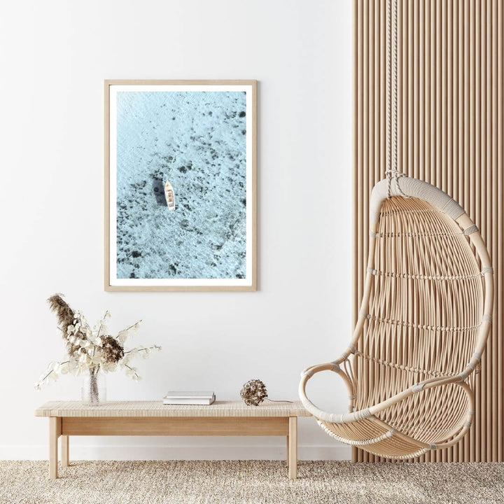 A wall art photo print of a white boat on a clear blue ocean off the Amalfi Coast Italy with a timber frame to decorate your hallway living room empty walls