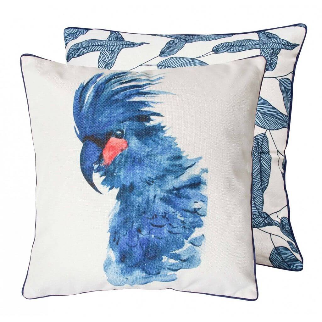 A beautiful scatter cushion with a blue cockatoo in the front and feathers at the back.