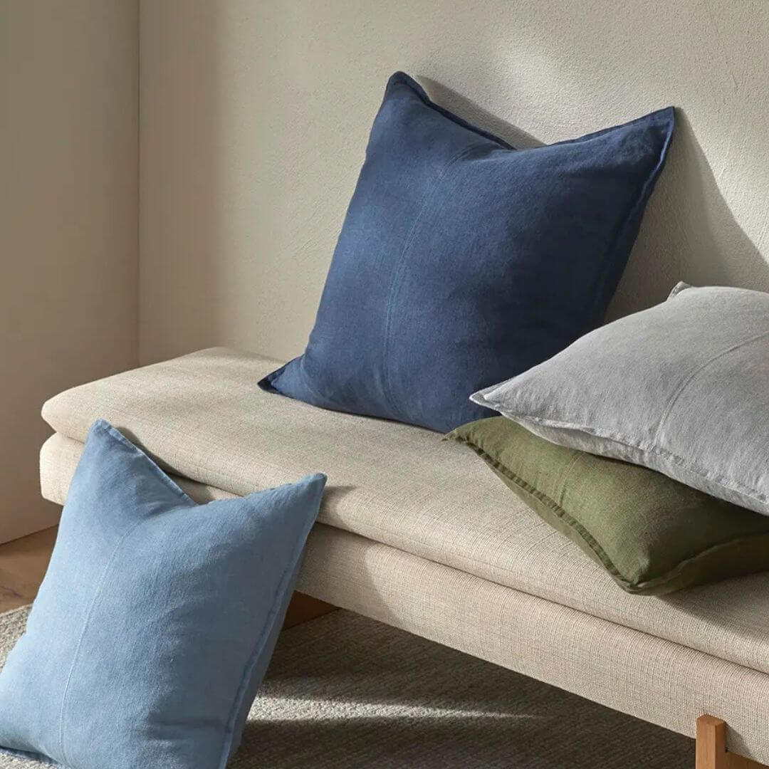 50cm and 60cm Como Linen Cushions in blue, green and grey on a bench