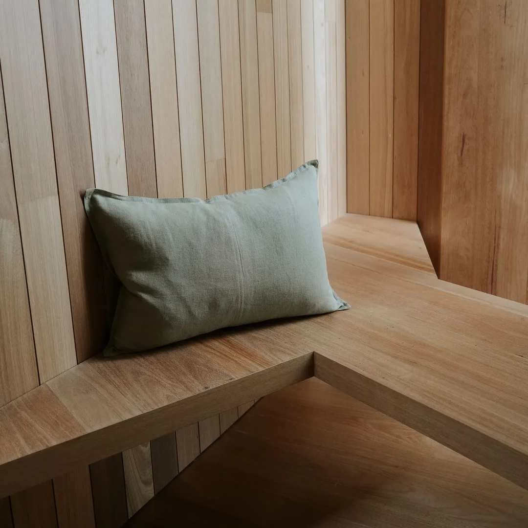 Light Green rectangle lumbar como linen cushion on a timber bench