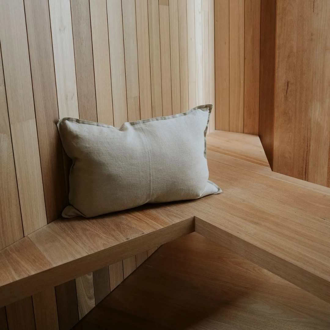 Sandstone cream rectangle lumbar como linen cushion on a timber bench