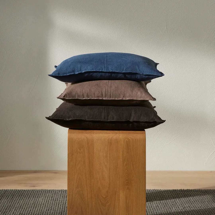 Como 50cm and 60cm Square linen cushion in blue and brown on a timber stool