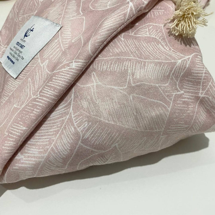 A soft, breathable Jersey Cotton Fitted Baby Cot Sheet in a pretty Palm Pink design.