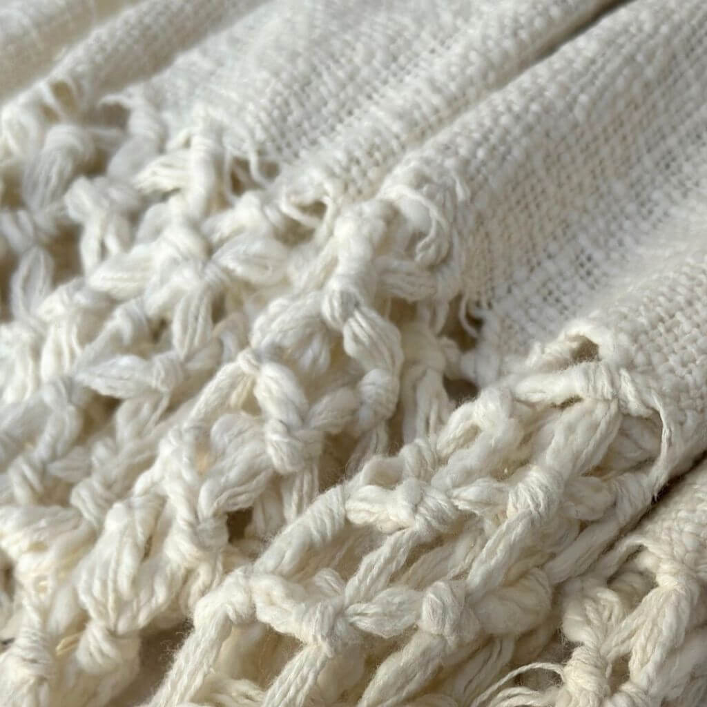 With her beautiful macrame pattern tassel edges , the Dove Cotton Throw in Ivory White measures 130cm x 170cm, perfect to decorate your bed or sofa