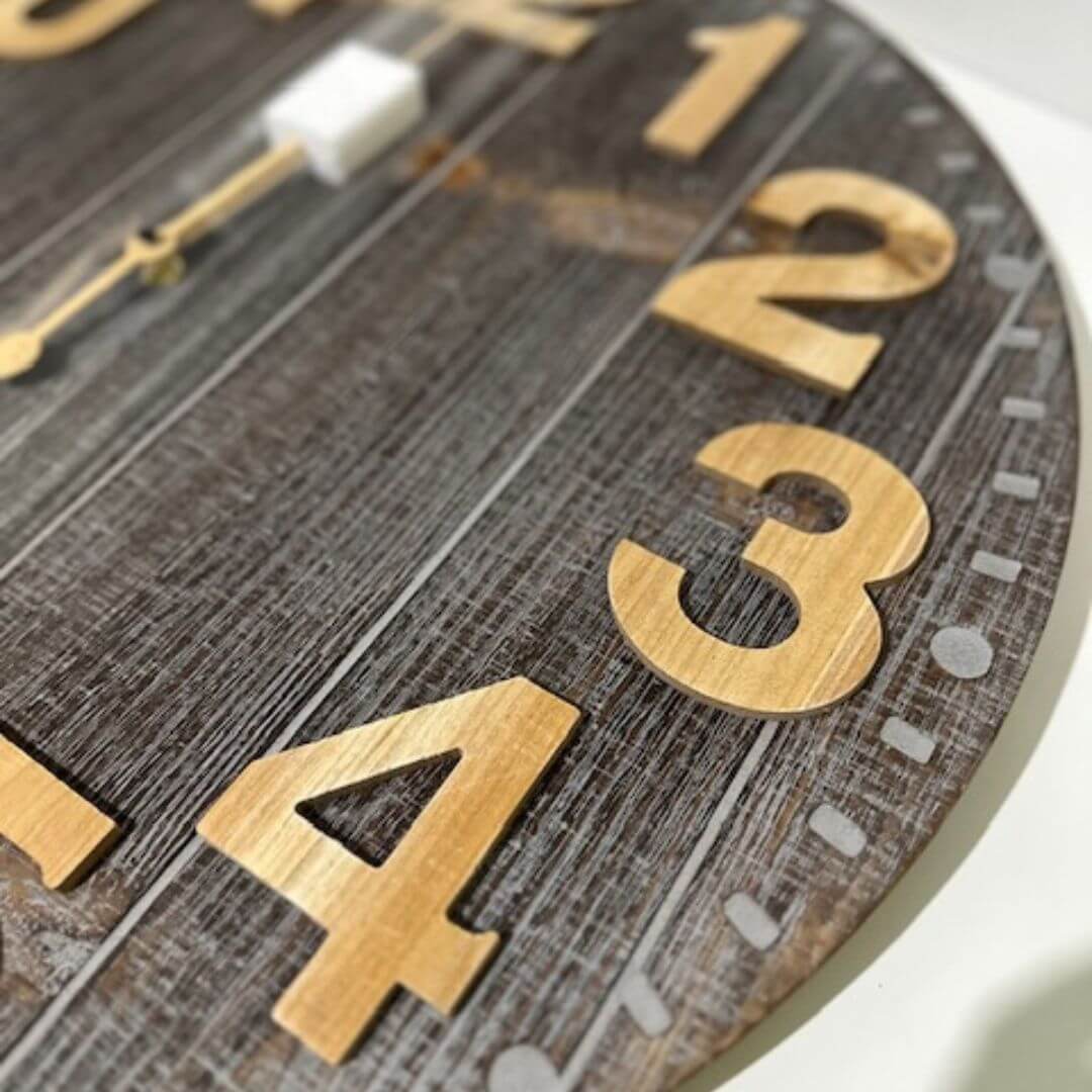 A large 60cm Emporium Slatted Aged Wall Clock with natural timber numbers and grey etched border.