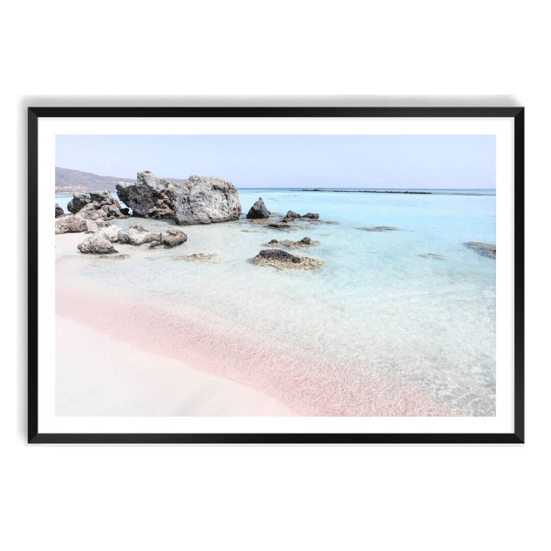 A wall art photo print of a pink beach in Greece with a black frame, white border by Beautiful Home Decor
