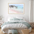 A coastal wall art photo print of a pink beach in Greece with a timber frame to style a coastal Australian bedroom