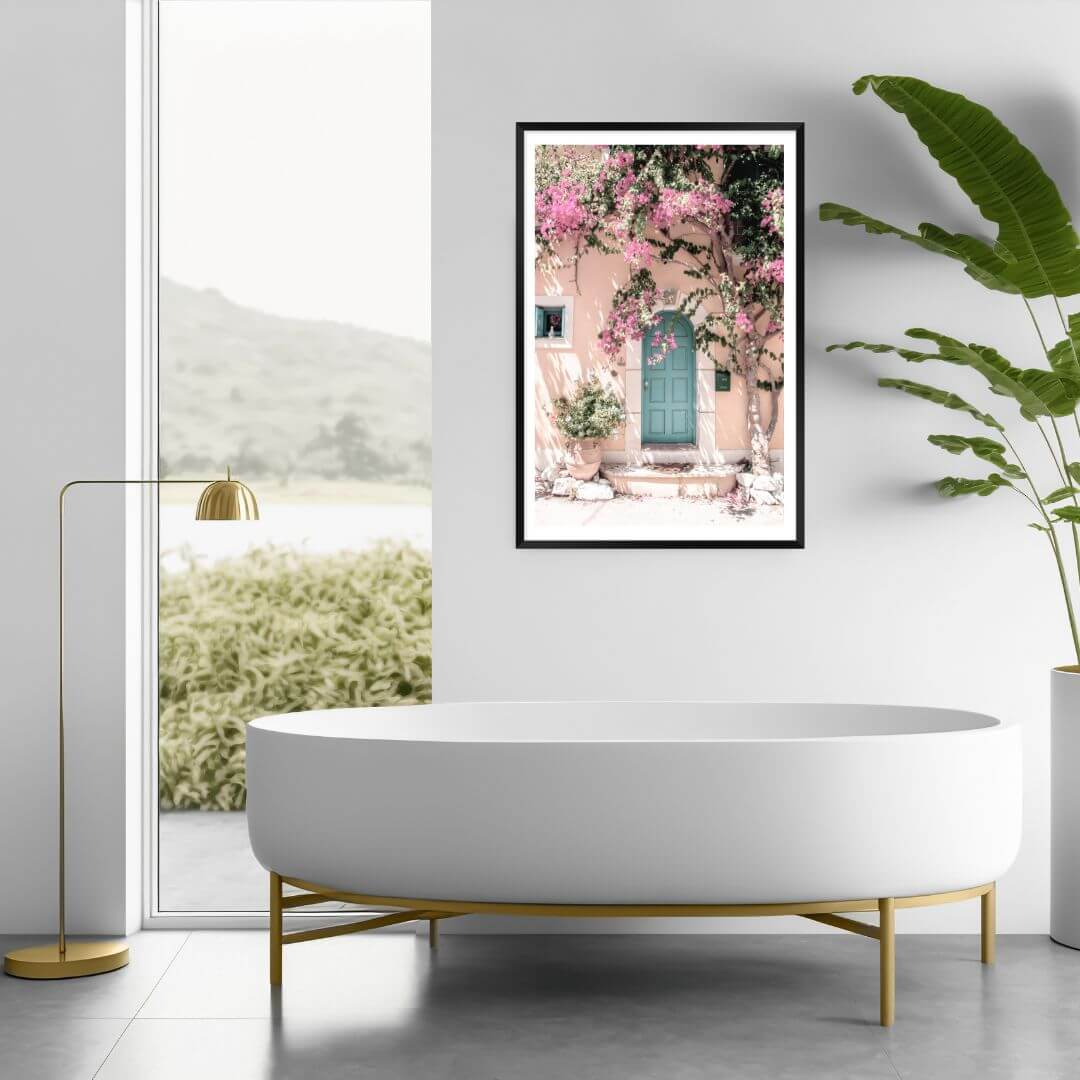 A Greek Pink Villa with Green Door Wall Art Photo Print framed in black on a bathroom wall by Beautiful Home Decor