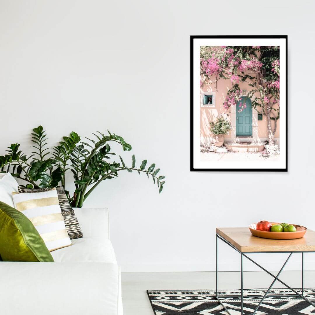 A Greek Pink Villa with Green Door Wall Art Photo Print black frame in a living room by Beautiful Home Decor