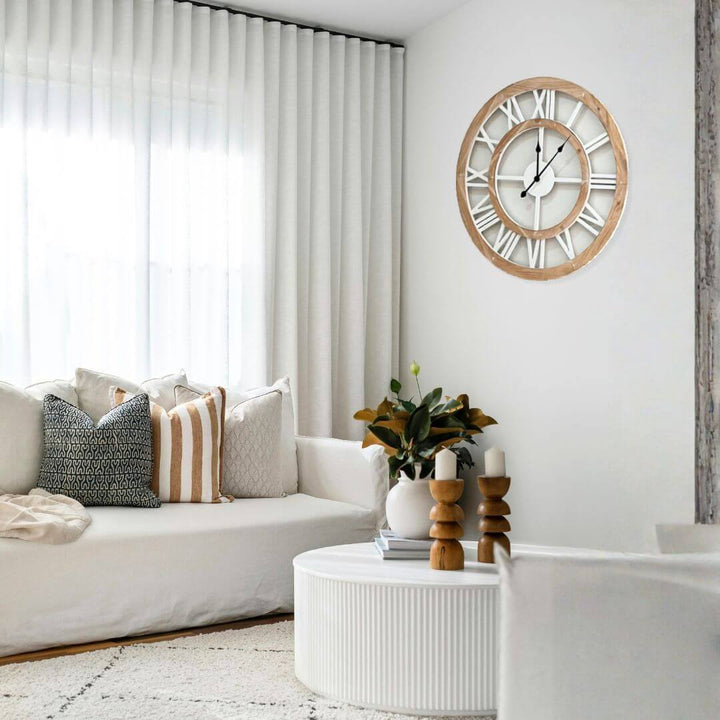 Living room with a white sofa, decorative pillows, a wooden coffee table, and a 60cm 80cm large wall clock.
