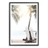 A wall art print of two white surf boards under the palm trees on a surfer beach in Hawaii in a black frame with a white border