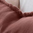 The Cotton fringe edge of a desert rose red cushion part of Square 50cm Luca Boho Fringe Linen Cushion and throw bundle set