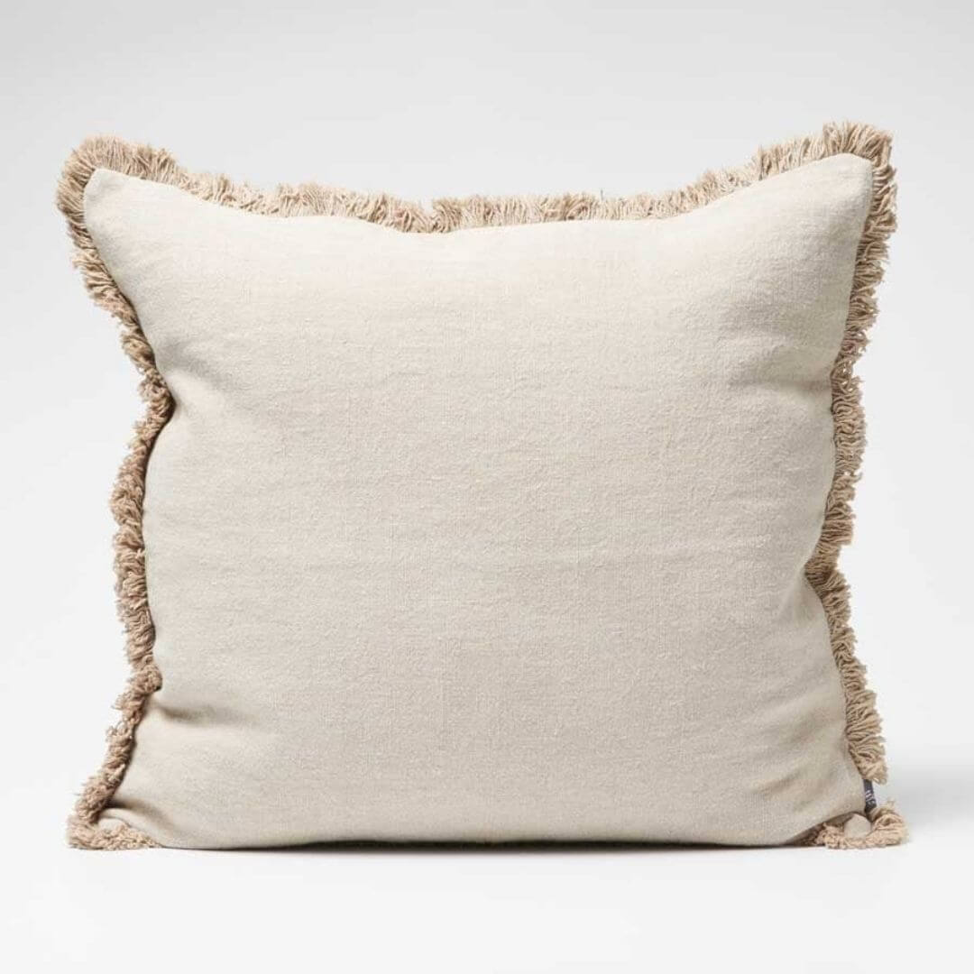 The natural coloured Square 60cm Luca Boho Fringe Cushion with cotton fringe edge.