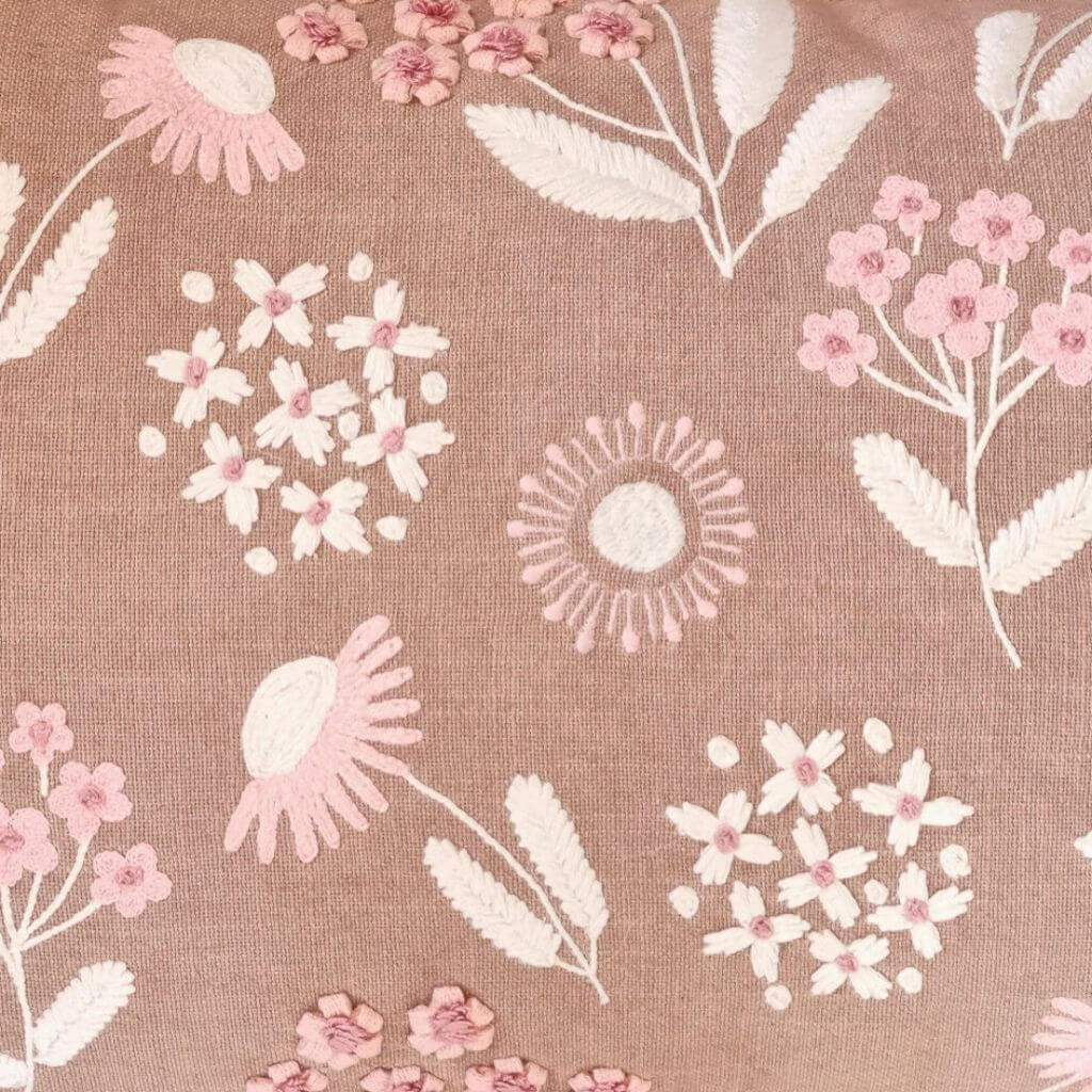 A close up view of the Posy Floral Embroidered Cushion in Warm Taupe, pink and cream, measures 35cm x 55cm rectangle, perfect to style your bedroom or living room.
