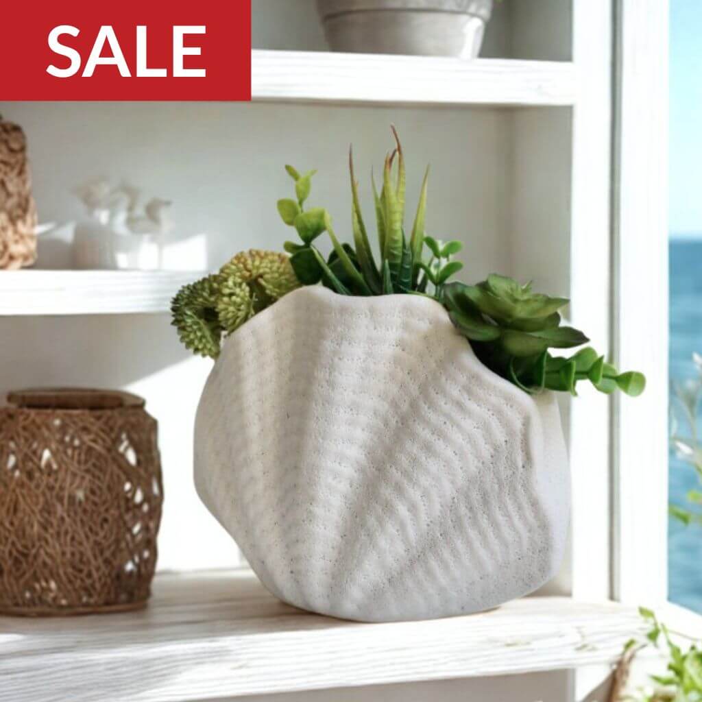 Decorative white vase with plants on a shelf with Black Friday Sale on home decor 