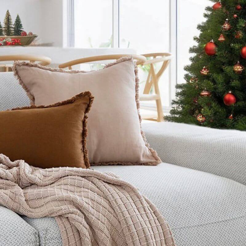 Christmas Beautiful home decor in Australia styled in a relaxed coastal living room with wall art, cushions and a throw 