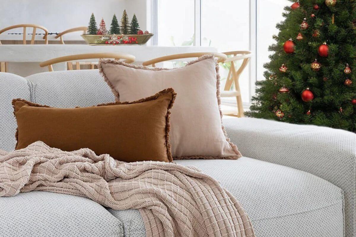 Beautiful Christmas home decor in Australia styled in a relaxed coastal living room with wall art, cushions and a throw 