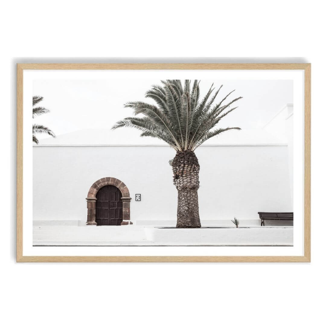A wall art photo print of a white Spanish Church with a Palm Tree  with a timber frame, white border by Beautiful Home Decor