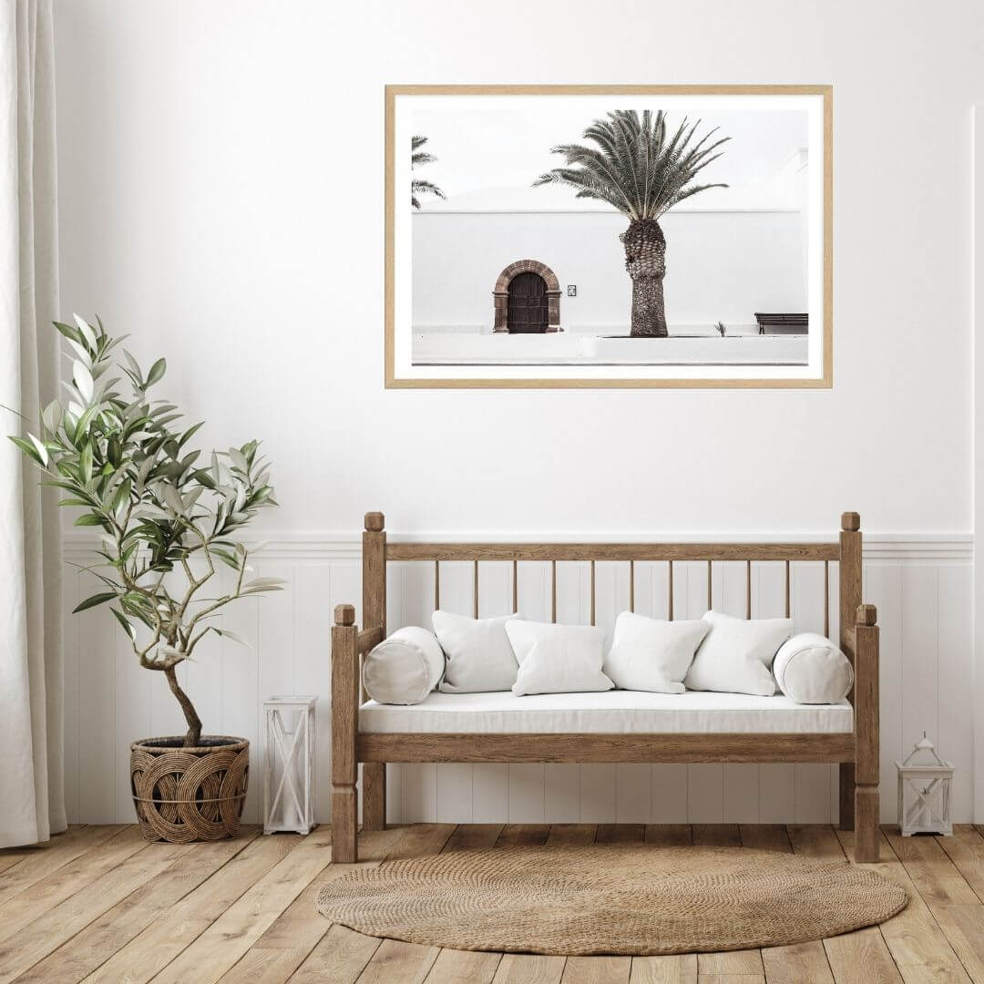 A wall art photo print of a white Spanish Church with a Palm Tree  with a timber frame for the hallway wall with free shipping