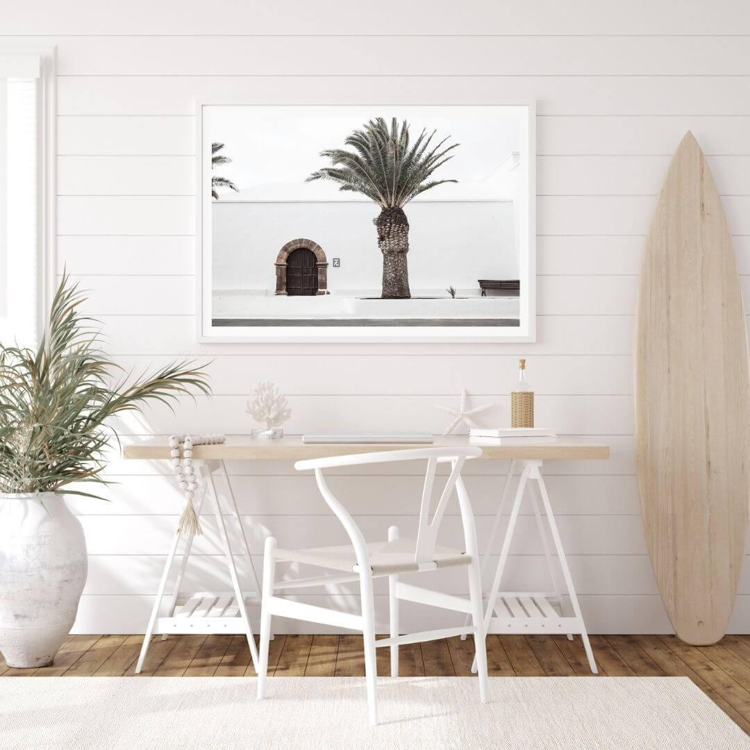 A wall art photo print of a white Spanish Church with a Palm Tree  with a white frame or unframed to decorate an empty wall