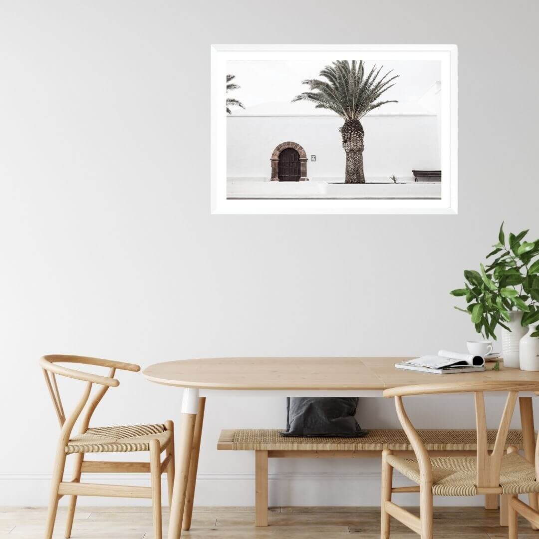 A wall art photo print of a white Spanish Church with a Palm Tree  with a white frame or unframed to style your dining room