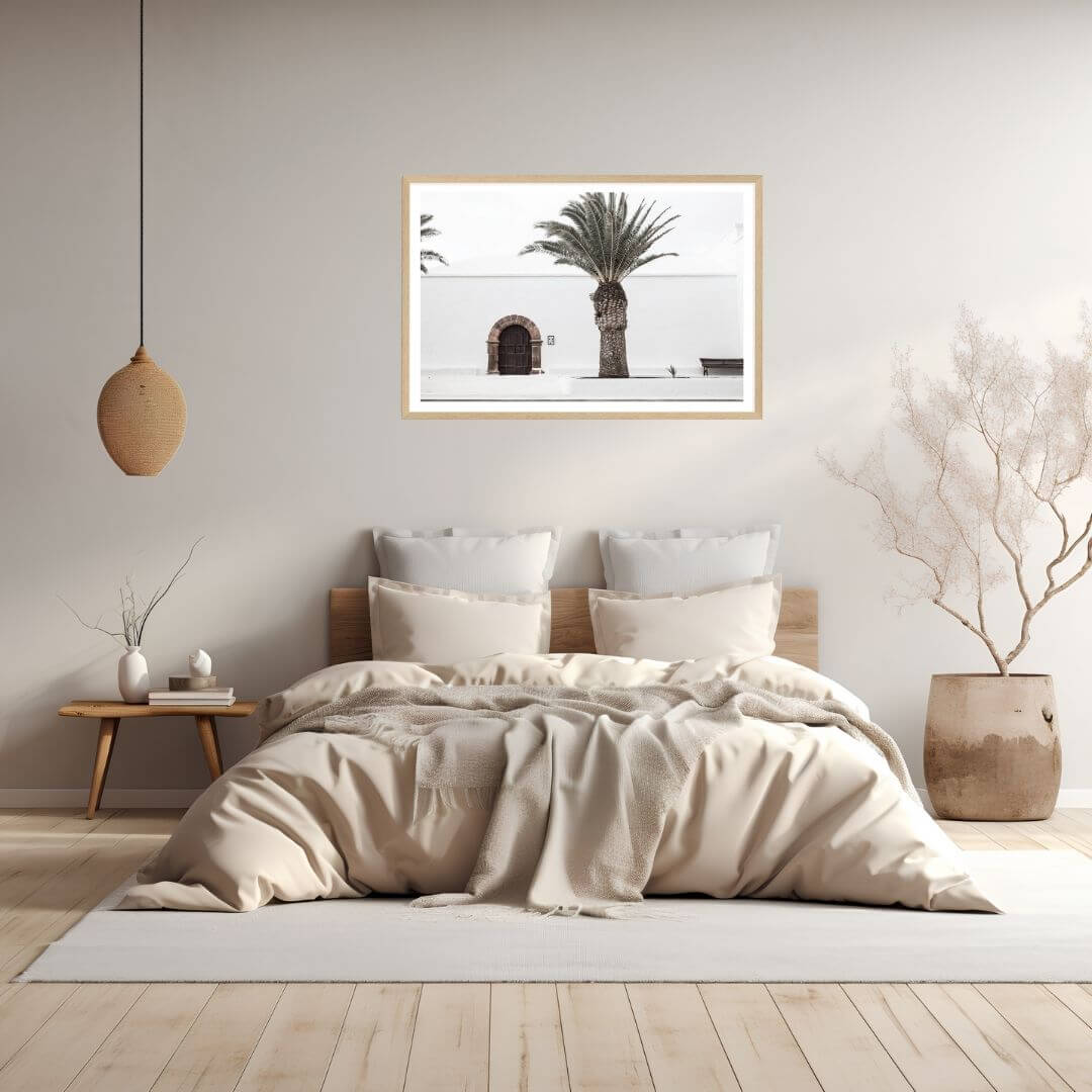 A wall art photo print of a white Spanish Church with a Palm Tree  with a timber frame to style a coastal Australian bedroom