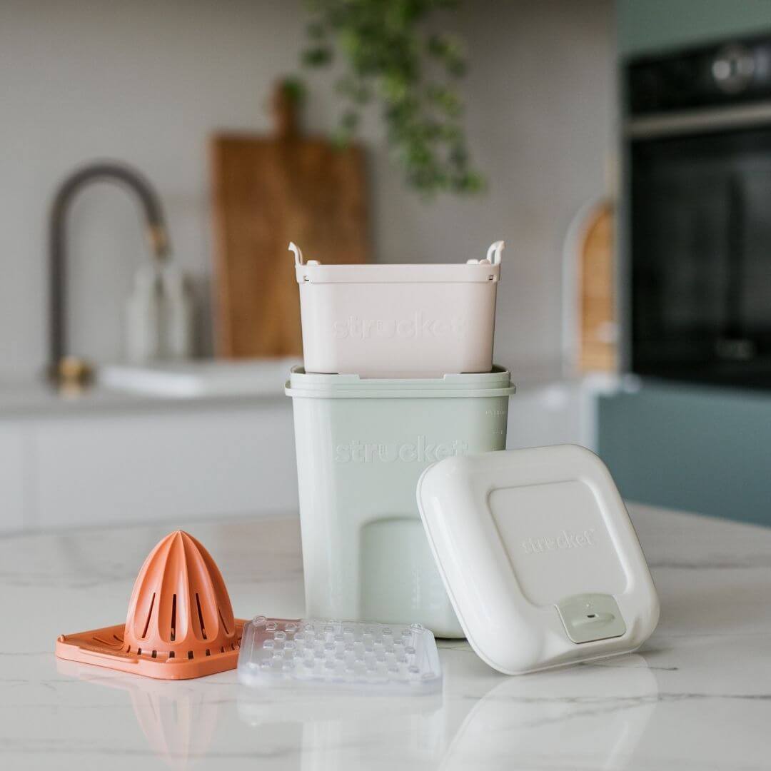 The Strucket Teenie Complete  Pack in Light Green with orange strainer and cheese grater set