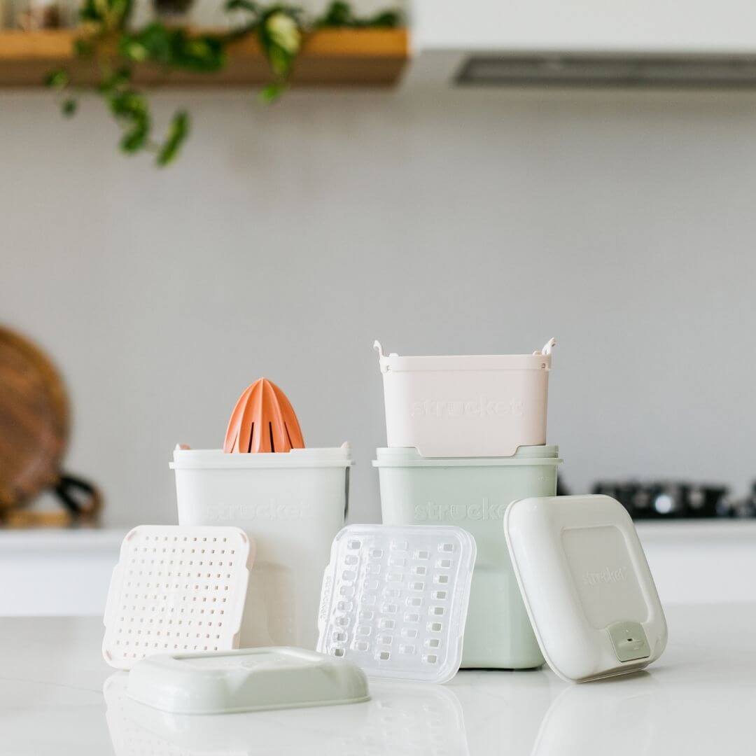 The Strucket Teenie Complete Pack with strainer, grater and juicer in light green and cool grey.