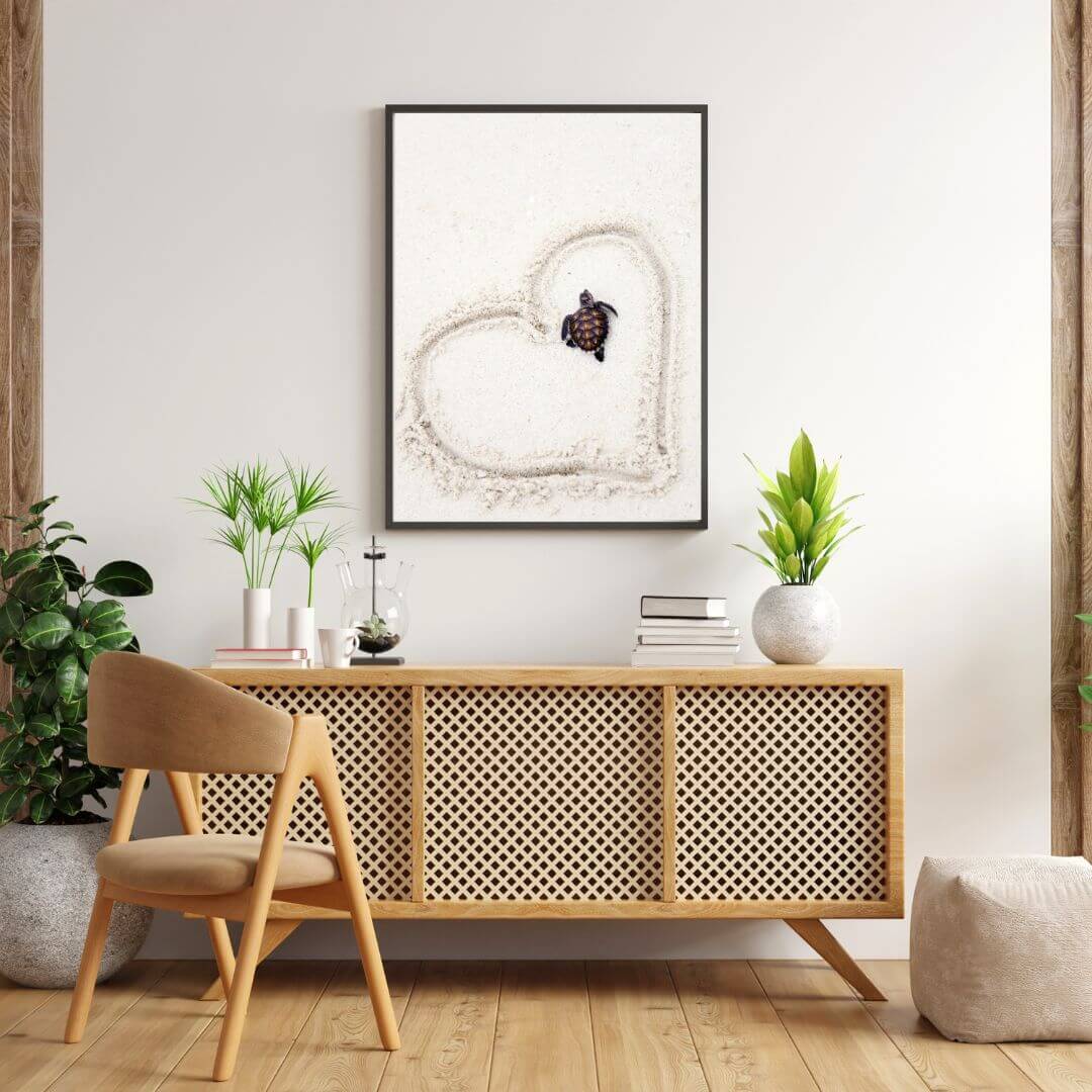 This adorable beach side artwork of a baby turtle on the sand with a heart drawn around it is available in print.  
