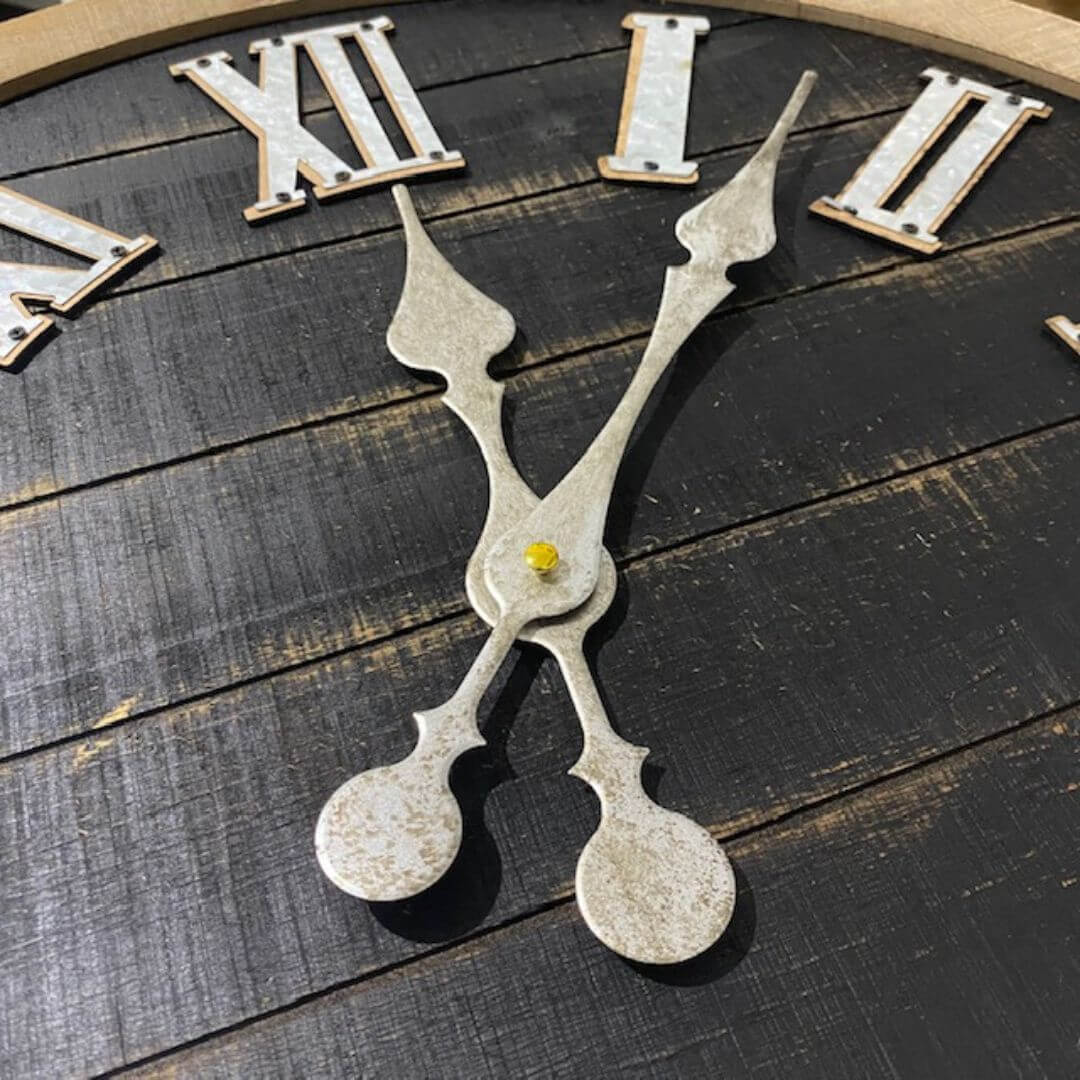 The Silver grey metal clock hands of the Vintage Industrial Large Black Wall Clock in 60 cm with metal Roman Numerals and clock hands