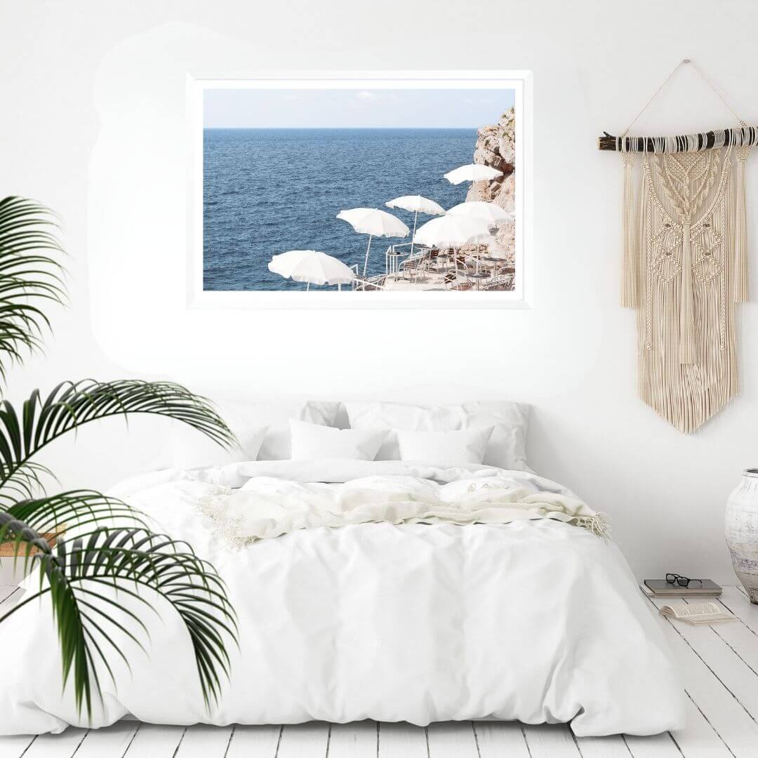A wall art photo print of white umbrellas on an Amalffi Coast Beach Italy with a white frame to decorate your bedroom walls