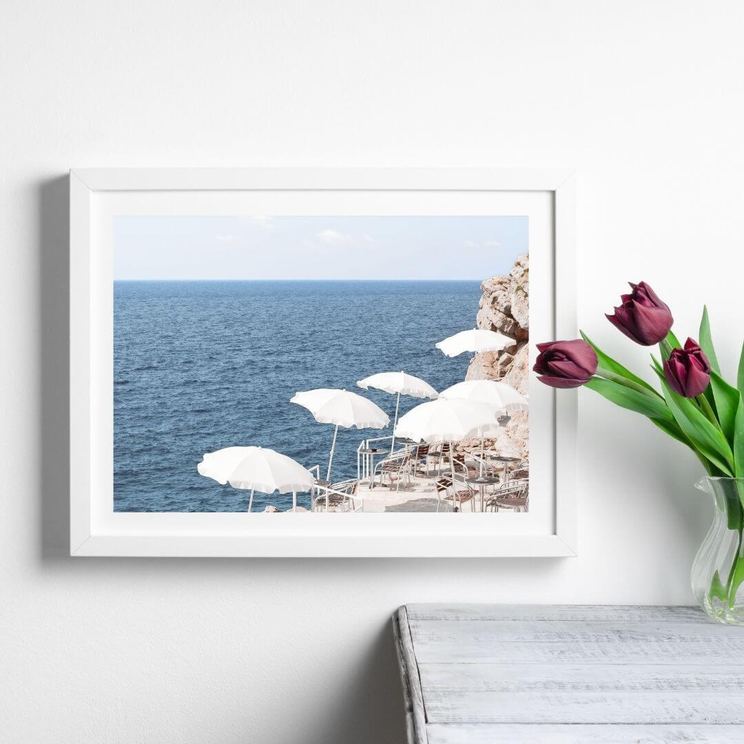 A wall art photo print of white umbrellas on an Amalffi Coast Beach Italy with a white frame or unframed to style shelves and empty walls