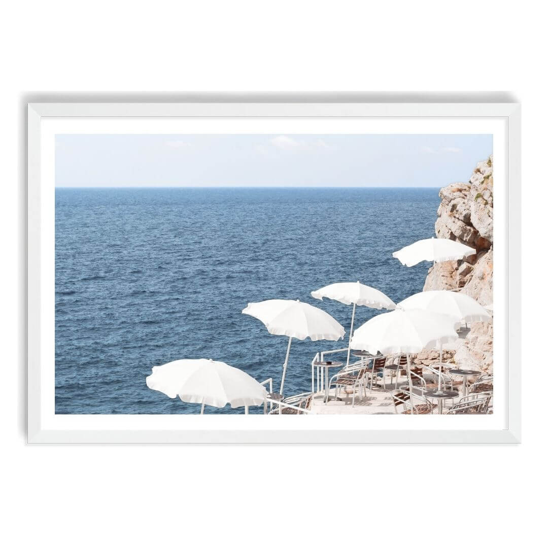 A wall art photo print of white umbrellas on an Amalffi Coast Beach Italy with a white frame, white border by Beautiful Home Decor