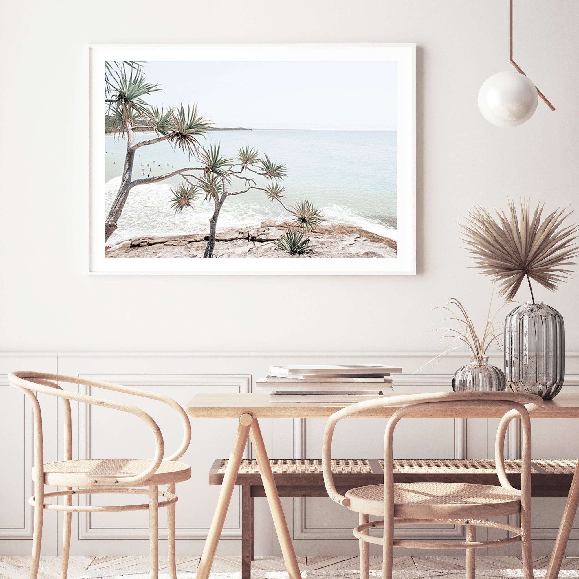 A coastal photographic artprint of Byron Bay's Watego Beach featuring surfers in the blue waves, available framed on unframed. 