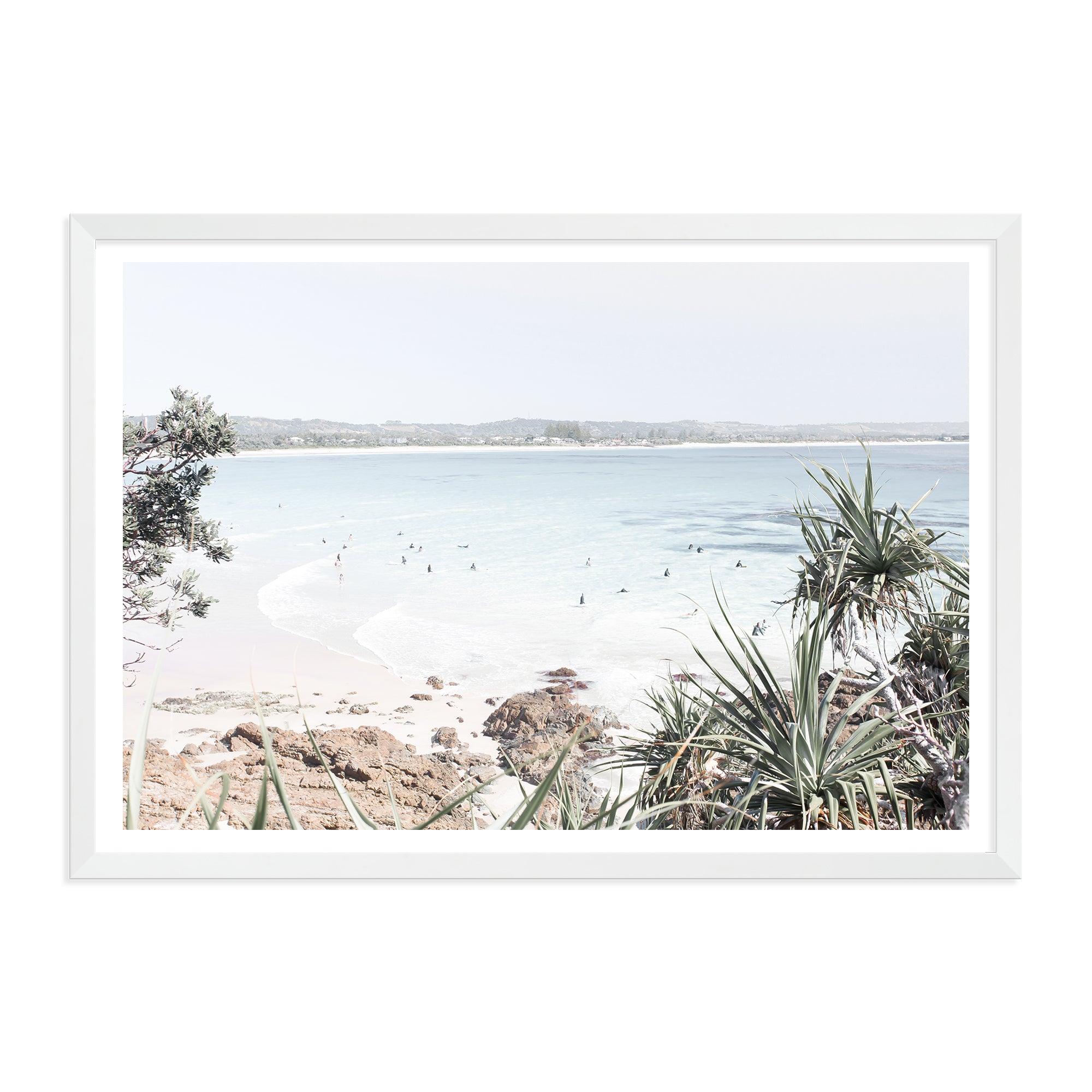 A coastal photographic artprint of Watego Beach in Byron Bay featuring surfers in the blue waves, available framed on unframed of Australian Surf Beach B.