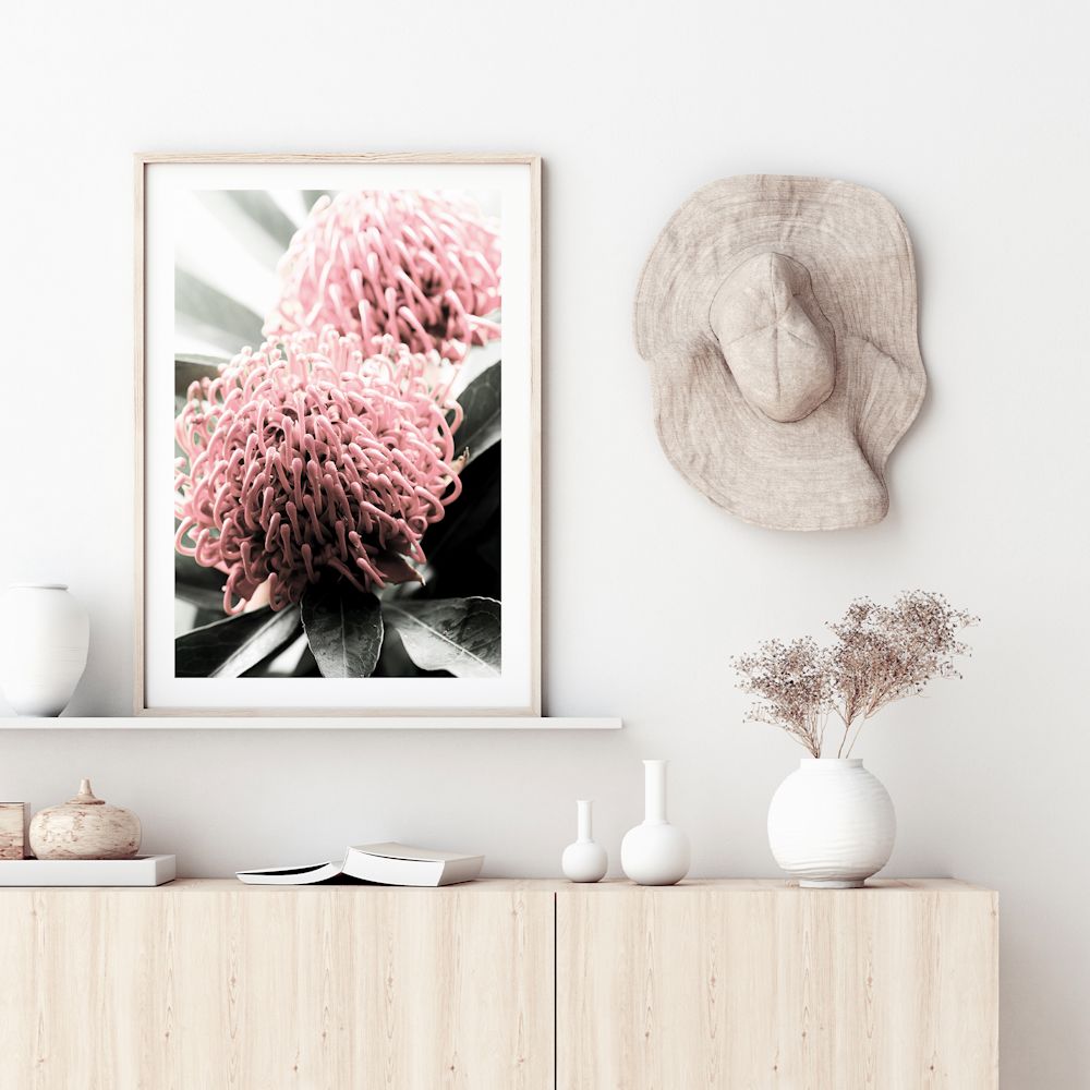 A beautiful floral artwork of two red Australian native Waratah flowers with muted green leaves in the background, available framed or unframed.