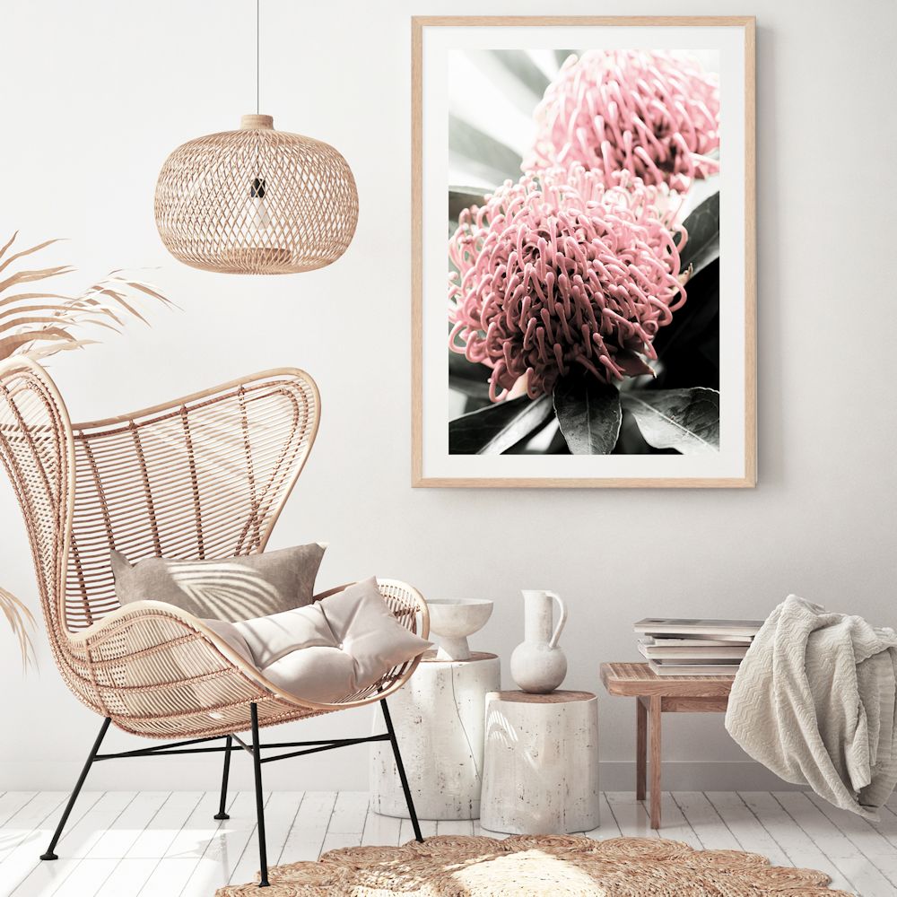 A photo floral wall art featuring two beautiful red Australian native Waratah flowers with muted green leaves in the background, available framed or unframed.