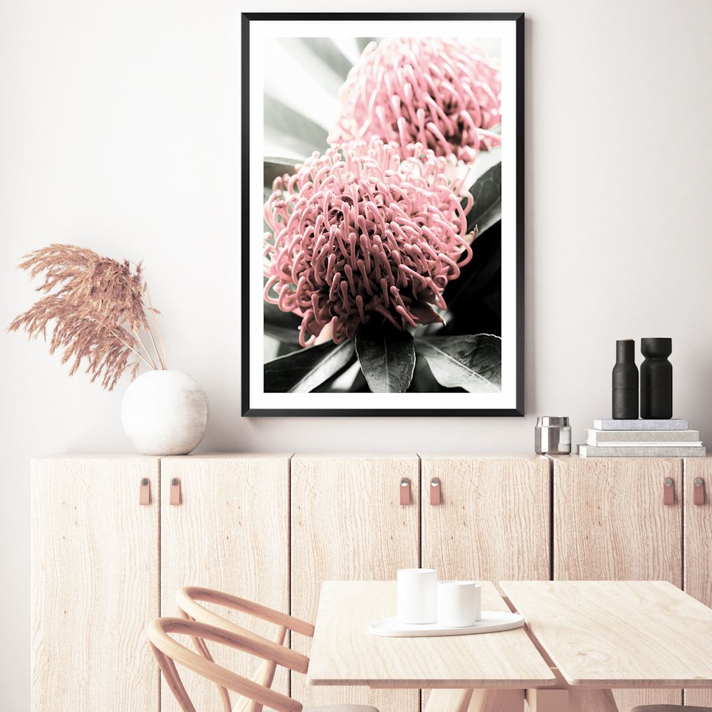A beautiful floral wall art featuring two red Australian native Waratah flowers with muted green leaves in the background, available in canvas and art prints.