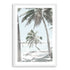 A photo artwork of a hammock between two palm trees on a tropical beach, available in canvas or print, framed or unframed.