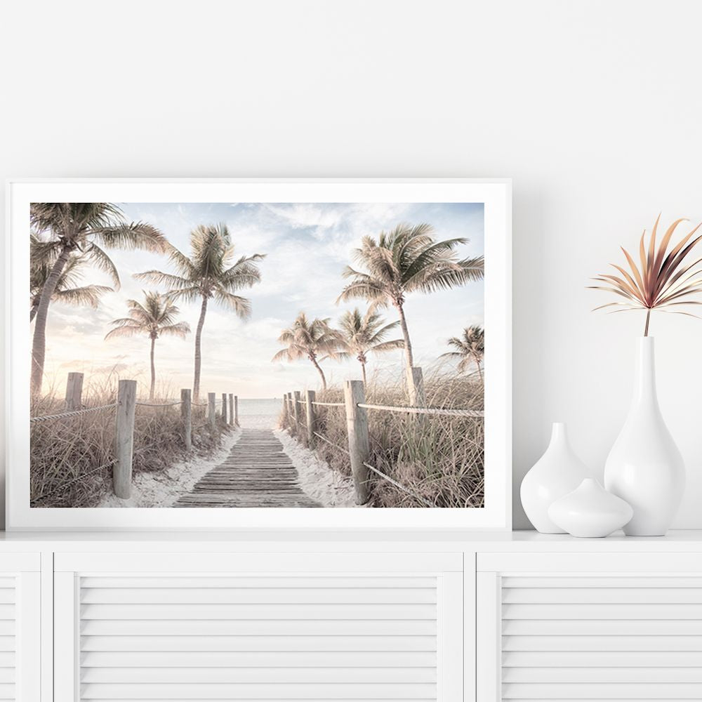 A coastal artwork featuring Florida Keys with a path to the beach framed by palm trees,  available unframed or framed.