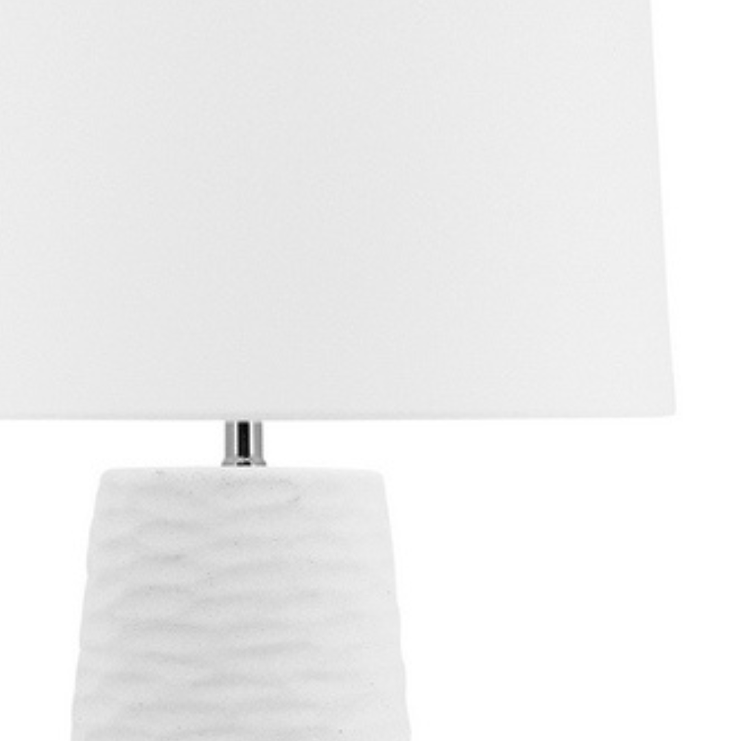 The gorgeous 62cm tall white Kima Table lamp has a textured wavy base and white lamp shade , perfect for your coastal home decor.