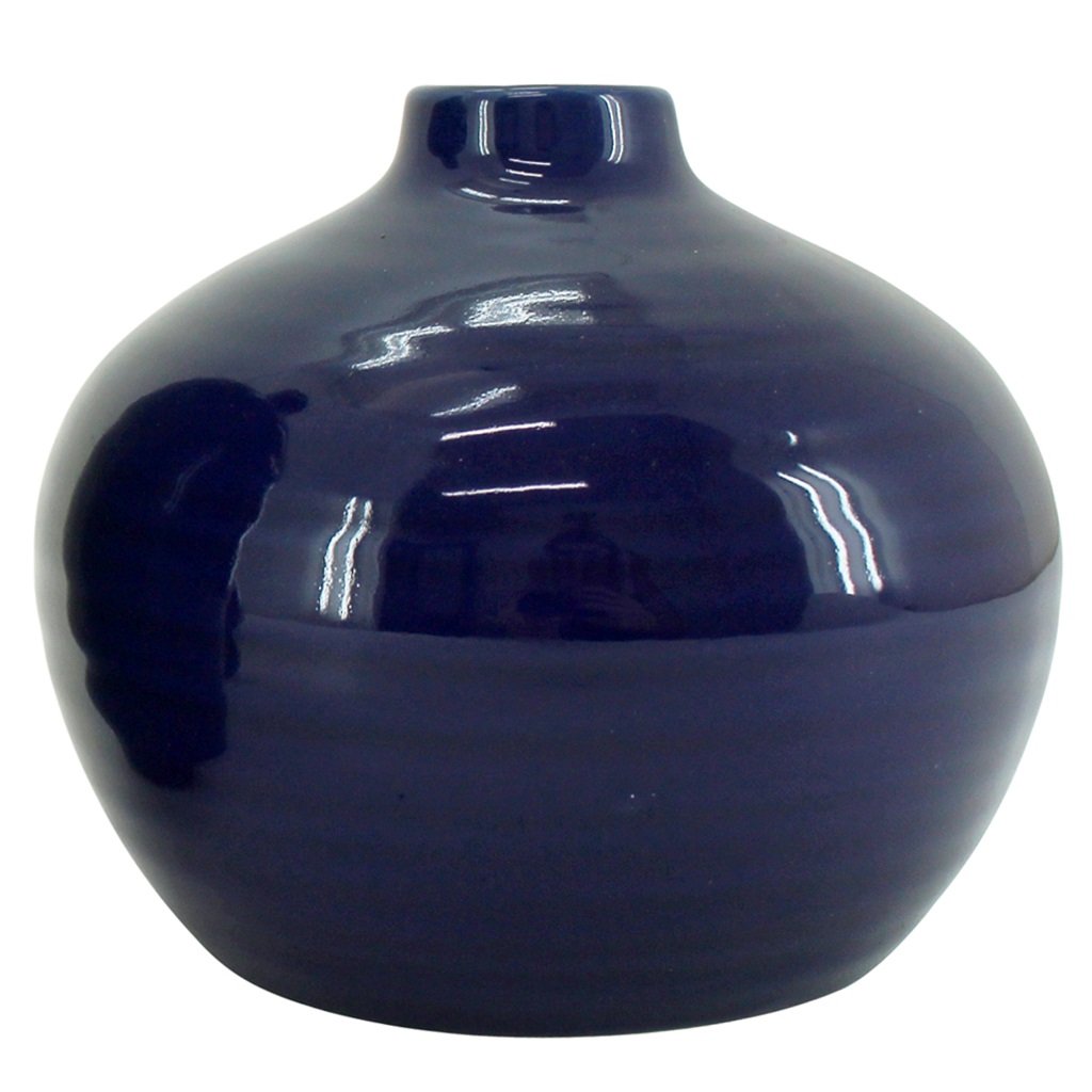 A Small Bud Vase in Indigo. With a smooth ceramic finish this stylish home decor vase will compliment your living space.
