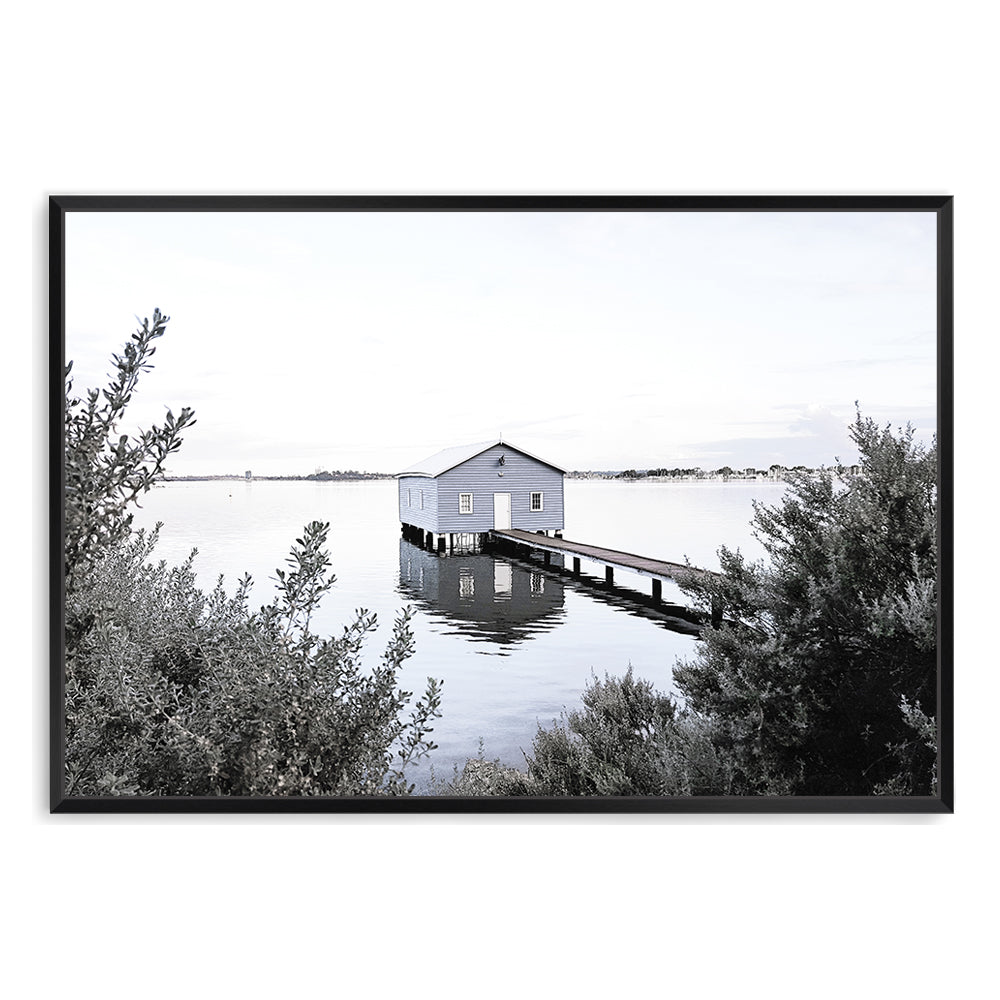 The calm and serene stretched canvas artwork features a lake and blue boat shed in Perth Australia, available unframed or with timber, white or black frames.