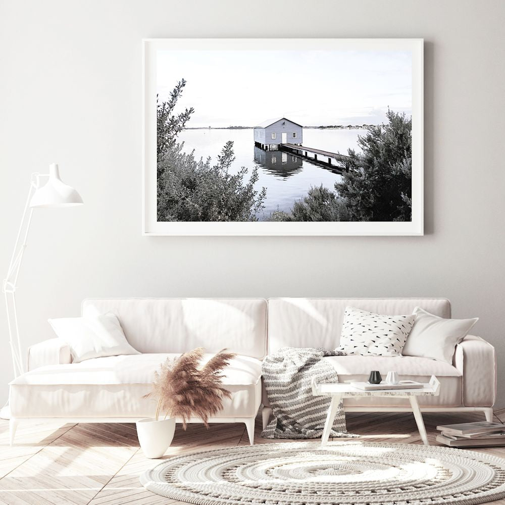 A calm and serene wall art print of a blue boat shed in Perth Australia, available in an unframed poster print, stretched canvas or with a timber, white or black frame.