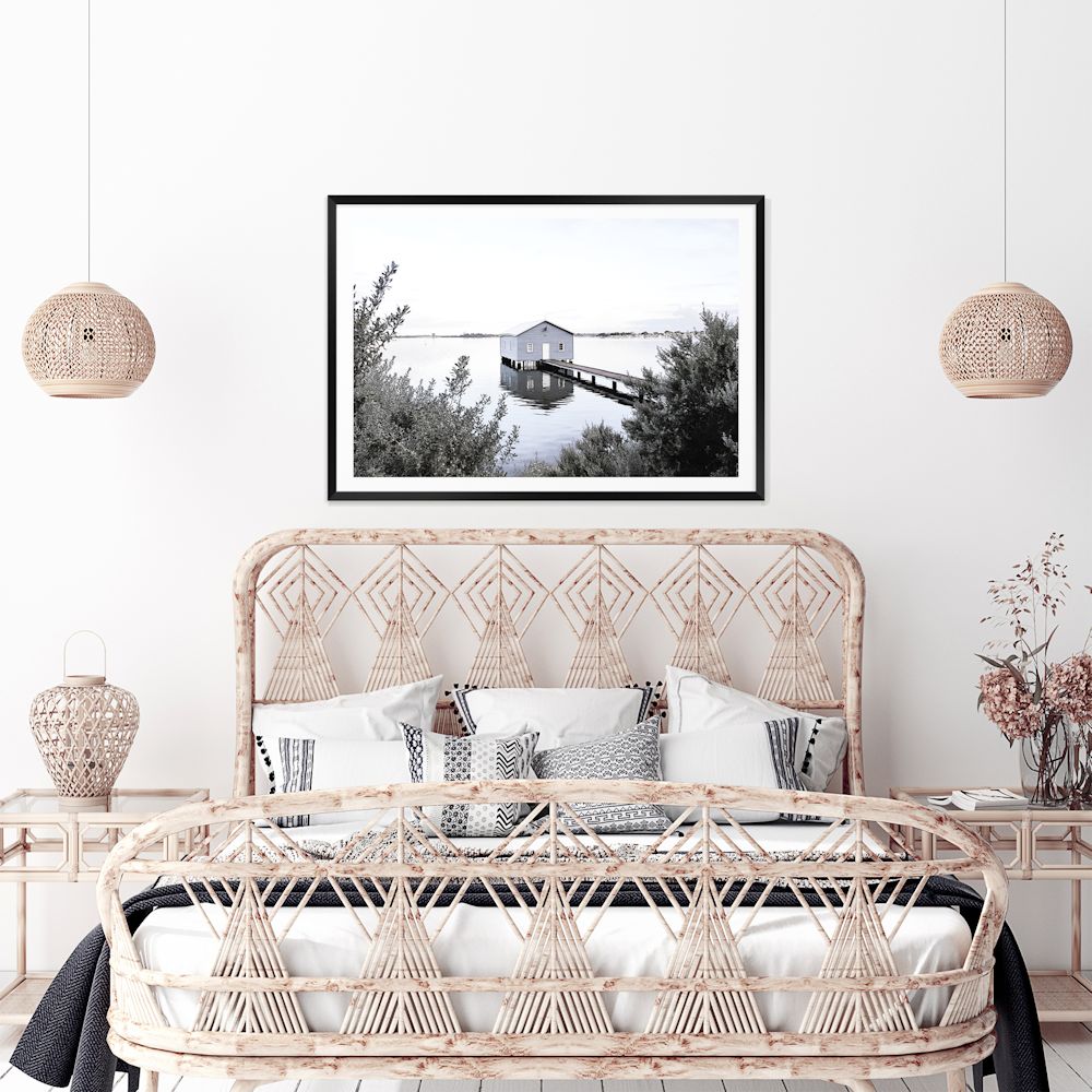 The calm and serene wall art print features a lake and blue boat shed in Perth Australia, available unframed or with a timber, white or black frame.